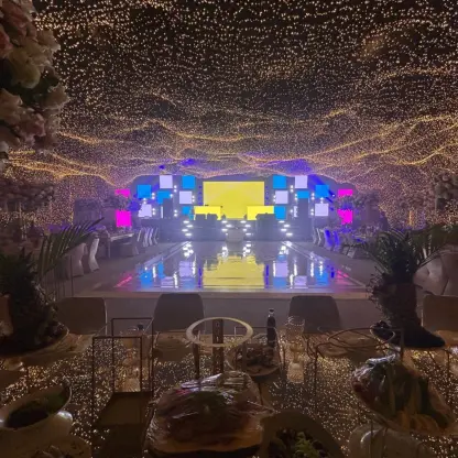 Grand Ballroom wedding reception with ceiling fairy lights and dance floor at SLS Playa Mujeres, Cancun