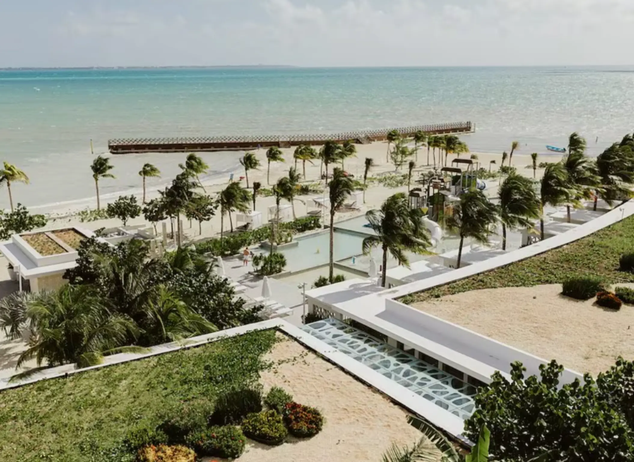Aerial view of the beach and pier wedding venue at SLS Playa Mujeres, Cancun
