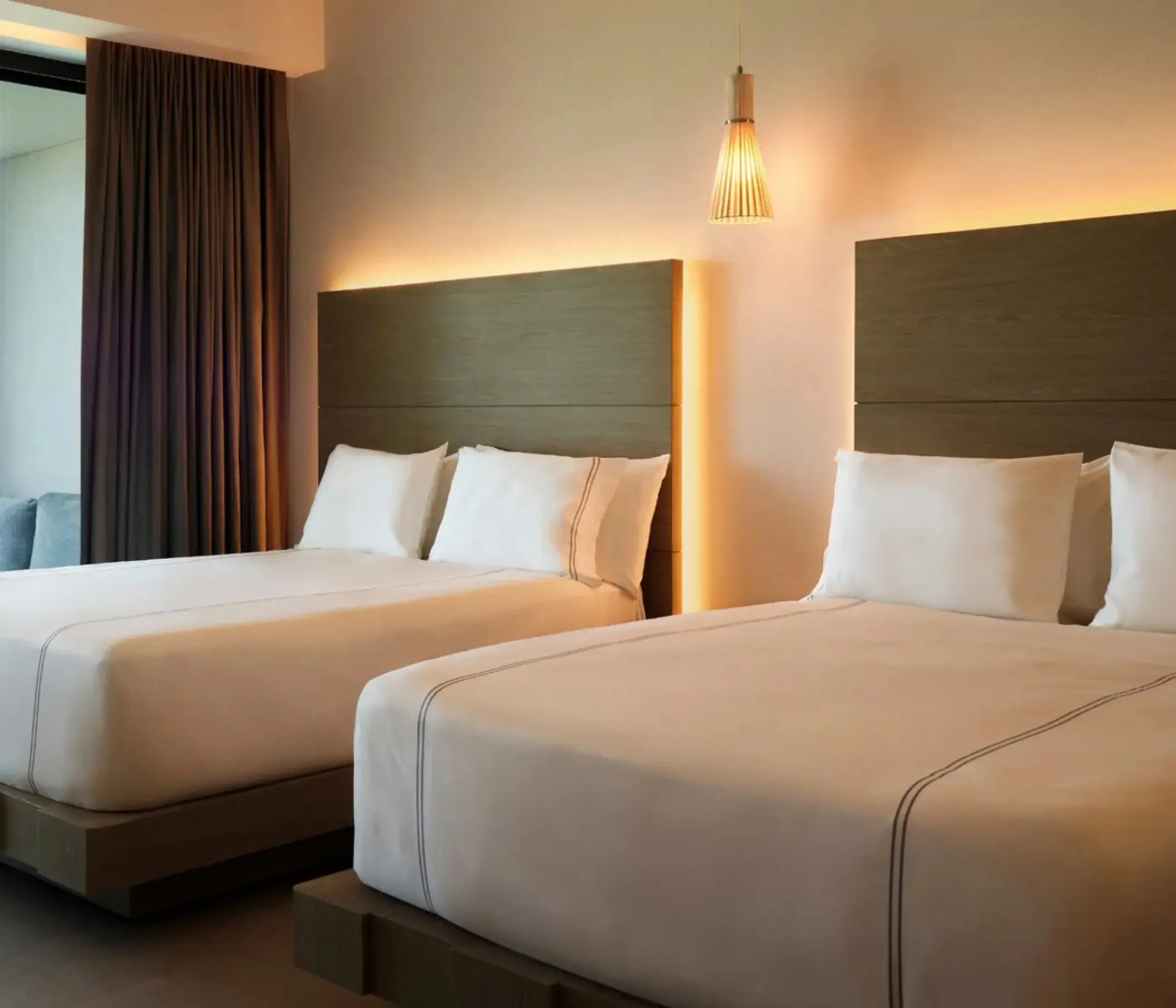 Modern guest suite with two queen beds at SLS Playa Mujeres, Cancun
