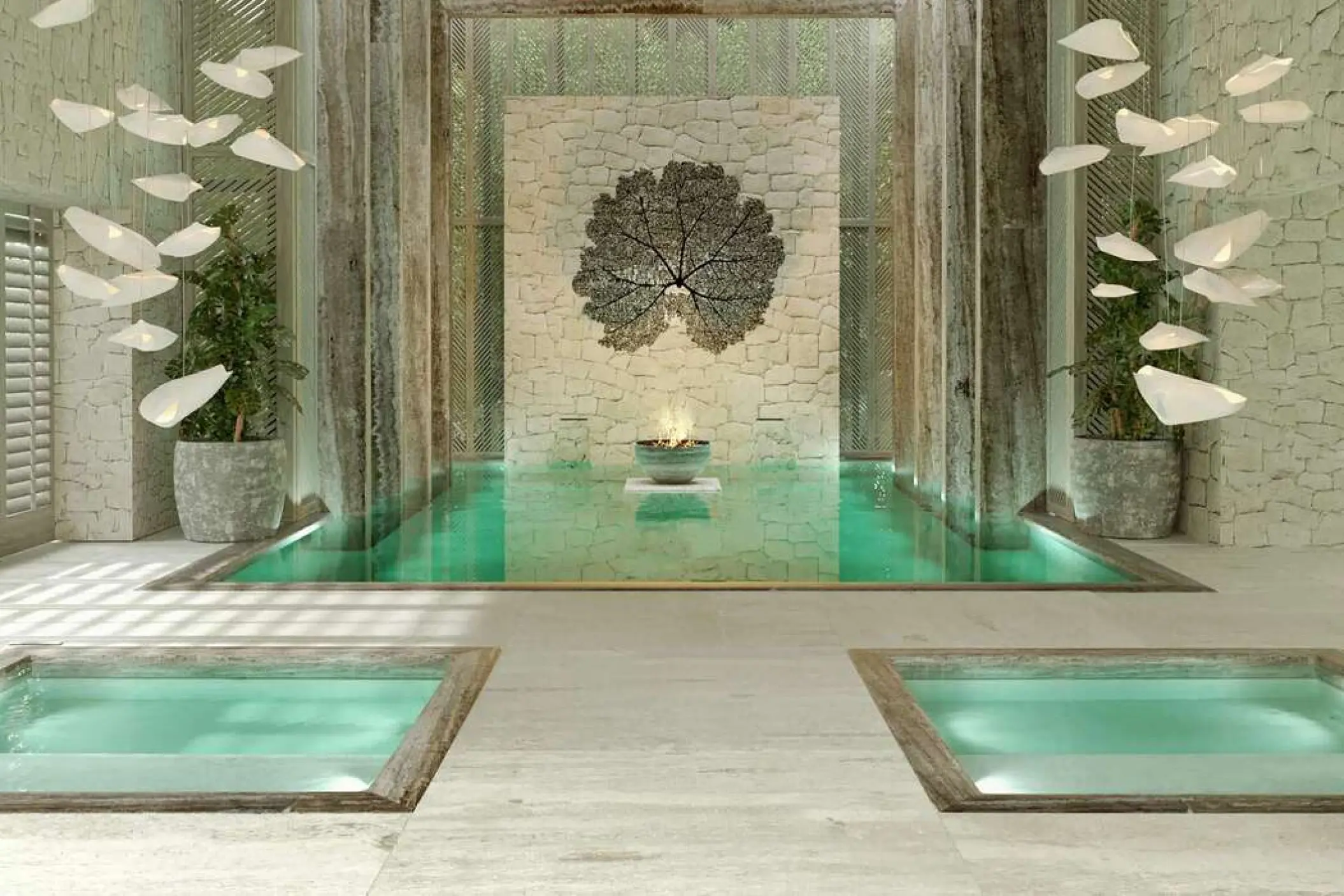 Indoor spa pools with stone walls and sculptural lighting at SLS Playa Mujeres, Cancun