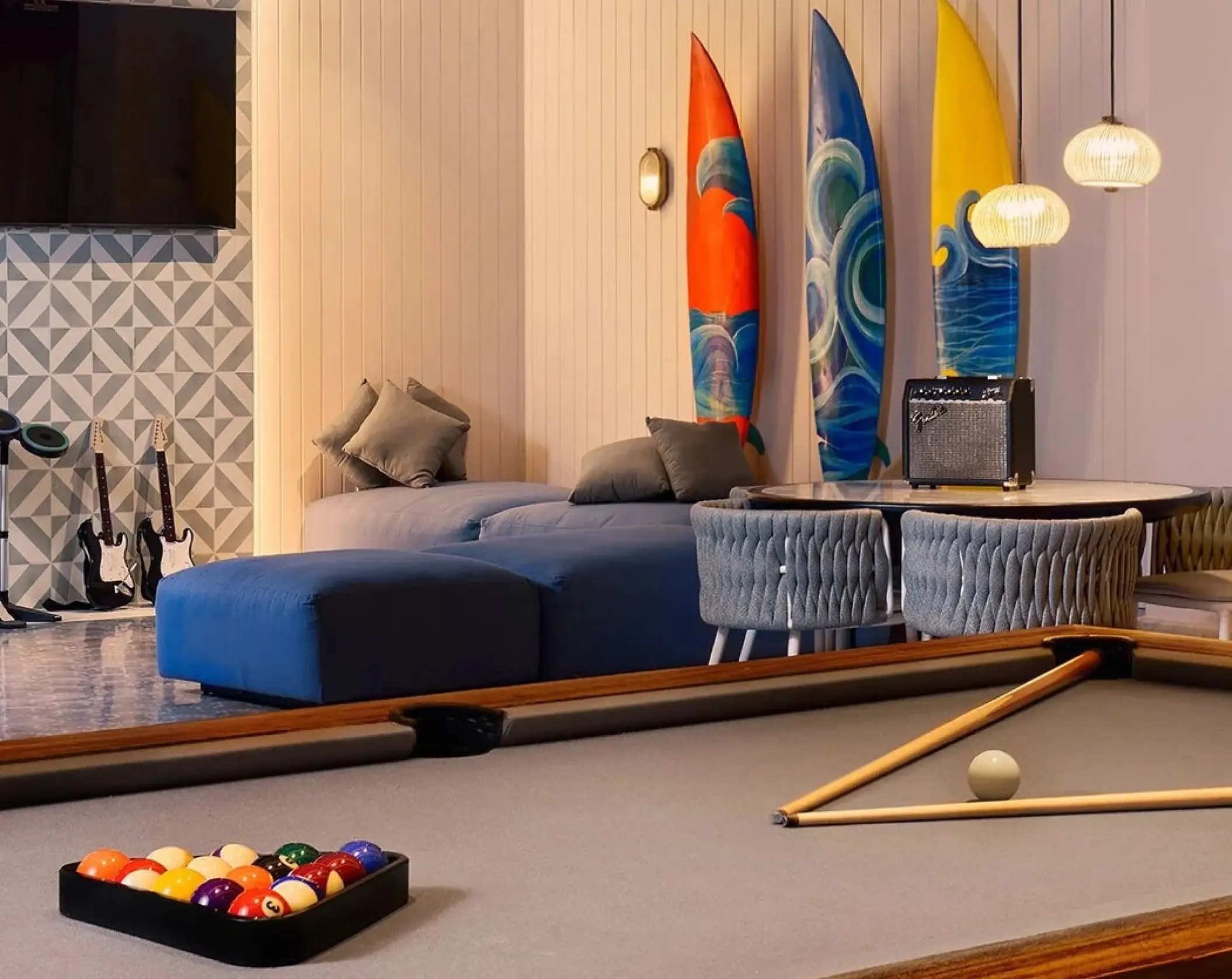 Teen lounge with pool table, surfboards, and lounge seating at SLS Playa Mujeres, Cancun