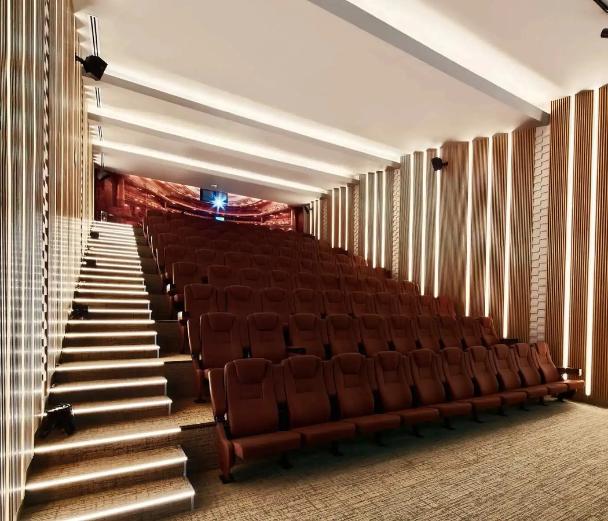 Modern theater with tiered seating and lighted stairs at SLS Playa Mujeres, Cancun