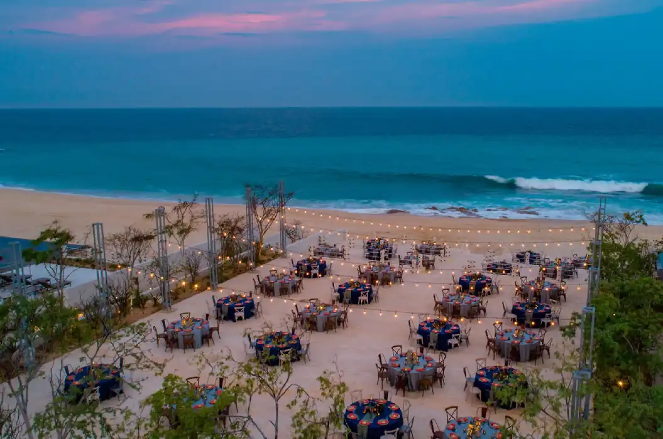 Beachfront wedding reception under string lights at Solaz Los Cabos, Cabo San Lucas