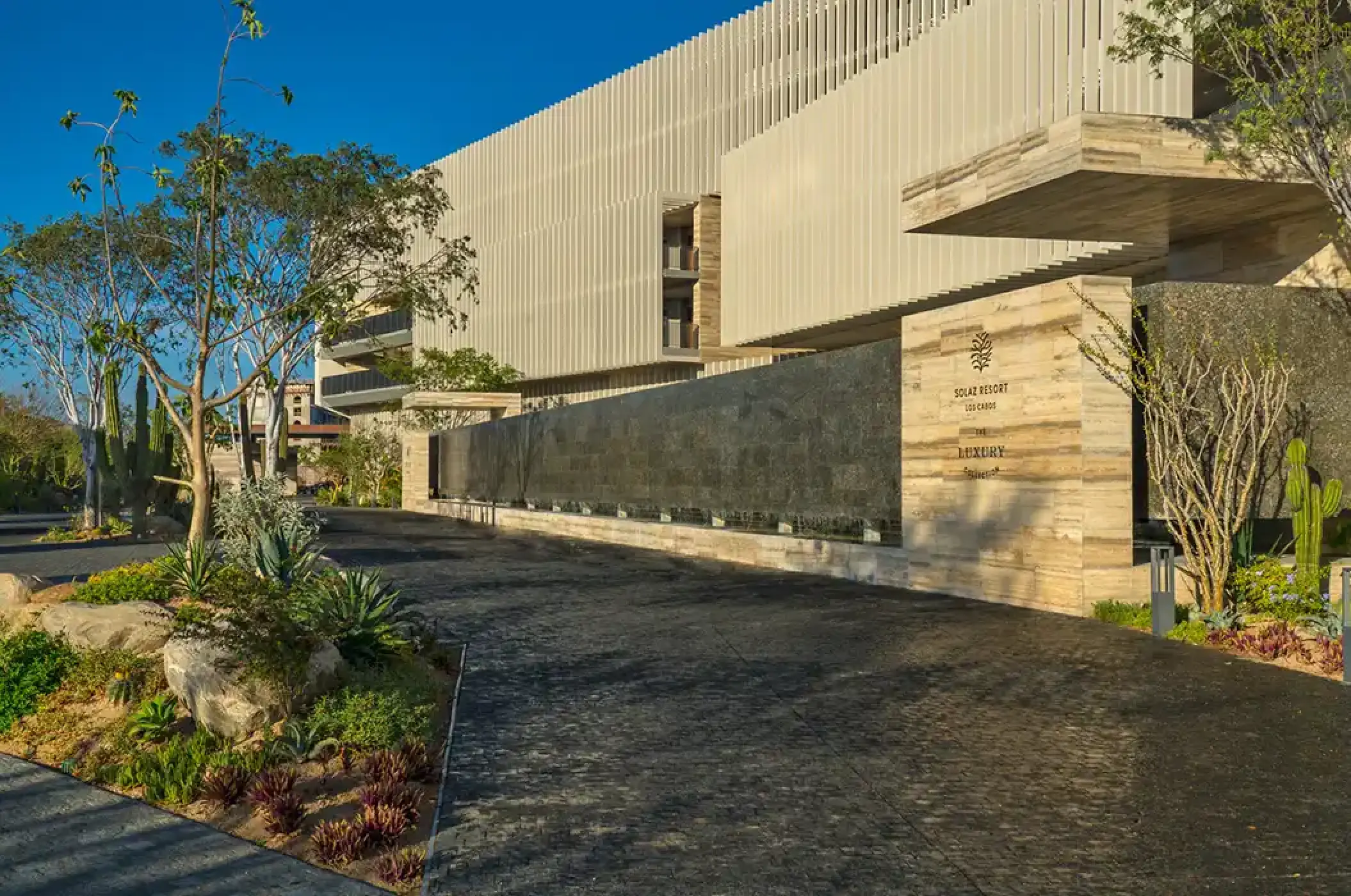 Modern stone and wood exterior entrance at Solaz Los Cabos, Cabo San Lucas