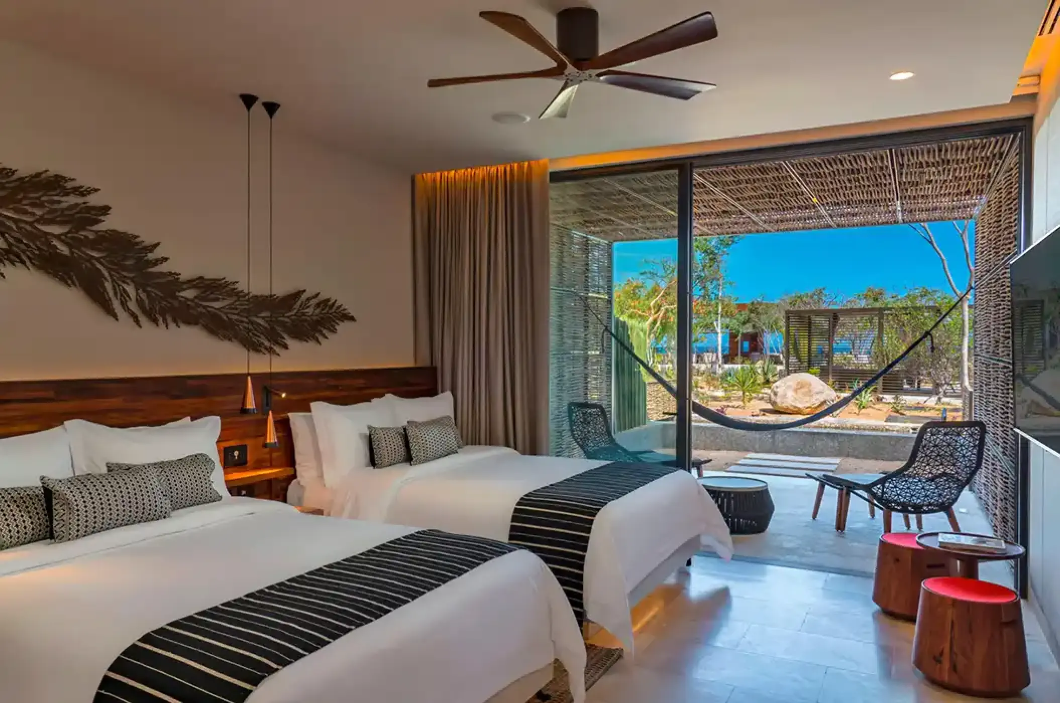 Modern guest room with two beds and a private terrace at Solaz Los Cabos, Cabo San Lucas