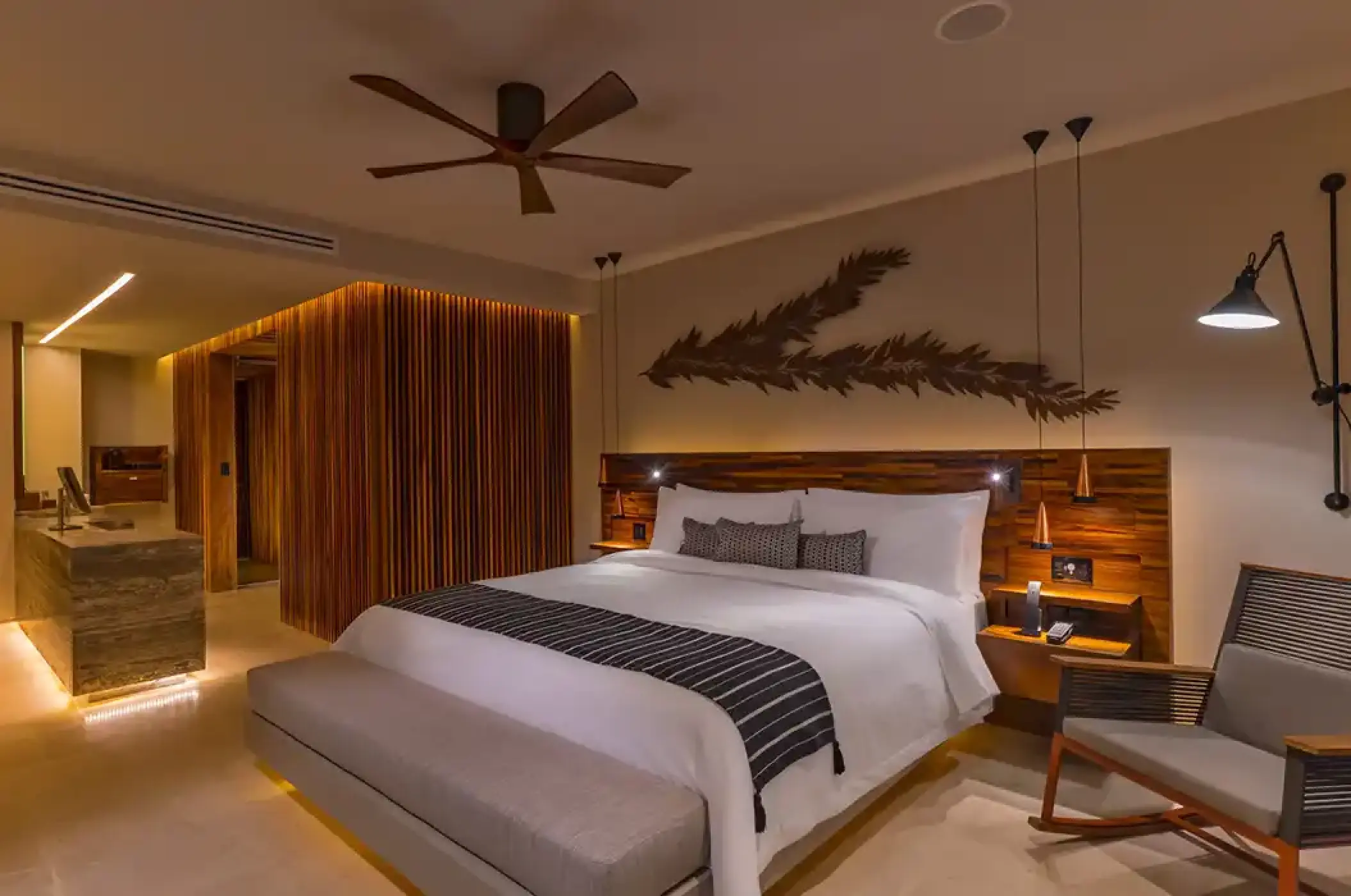 Modern king suite with wood accents and a ceiling fan at Solaz Los Cabos, Cabo San Lucas