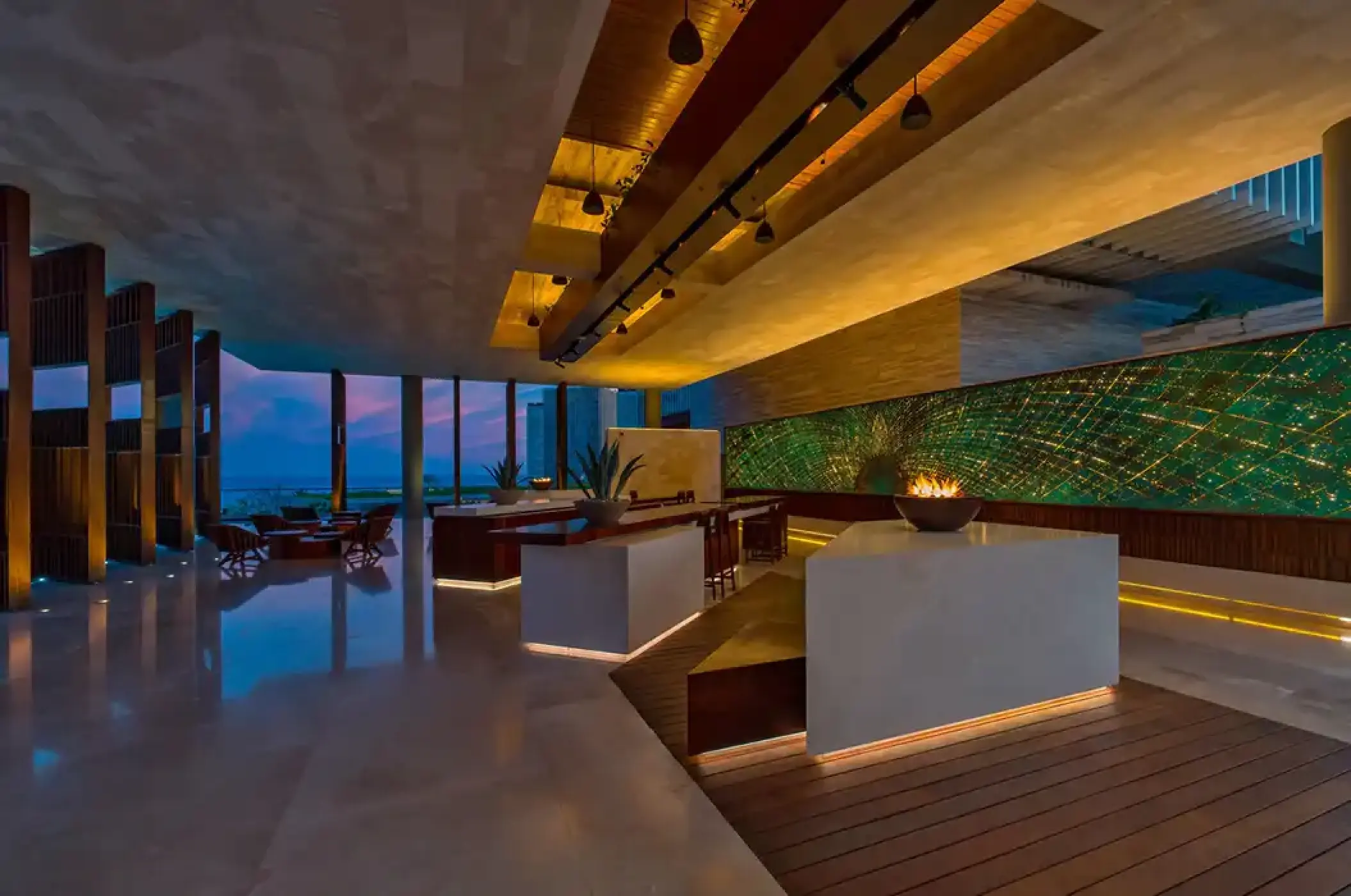 Modern open-air lobby with fire pit and green wall at Solaz Los Cabos, Cabo San Lucas