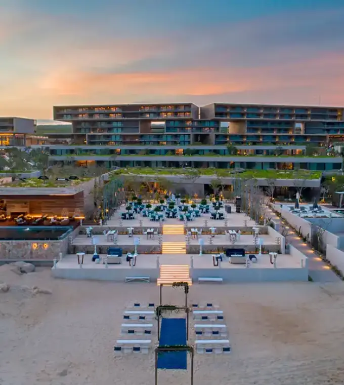Aerial view of the modern beachfront exterior and tiered terraces at Solaz Los Cabos, Cabo San Lucas