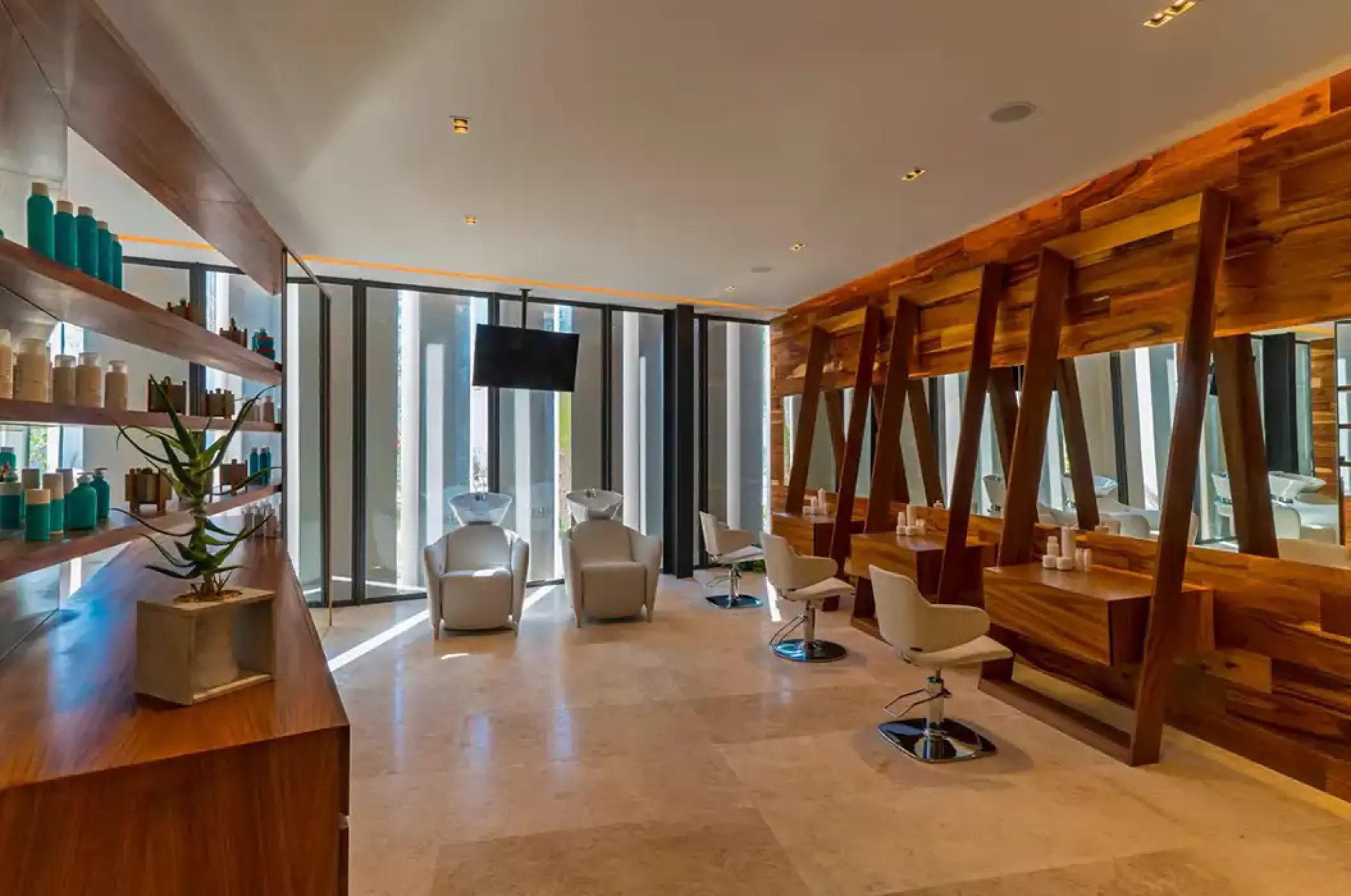 Modern hair salon with wooden accents and white styling chairs at Solaz Los Cabos, Cabo San Lucas