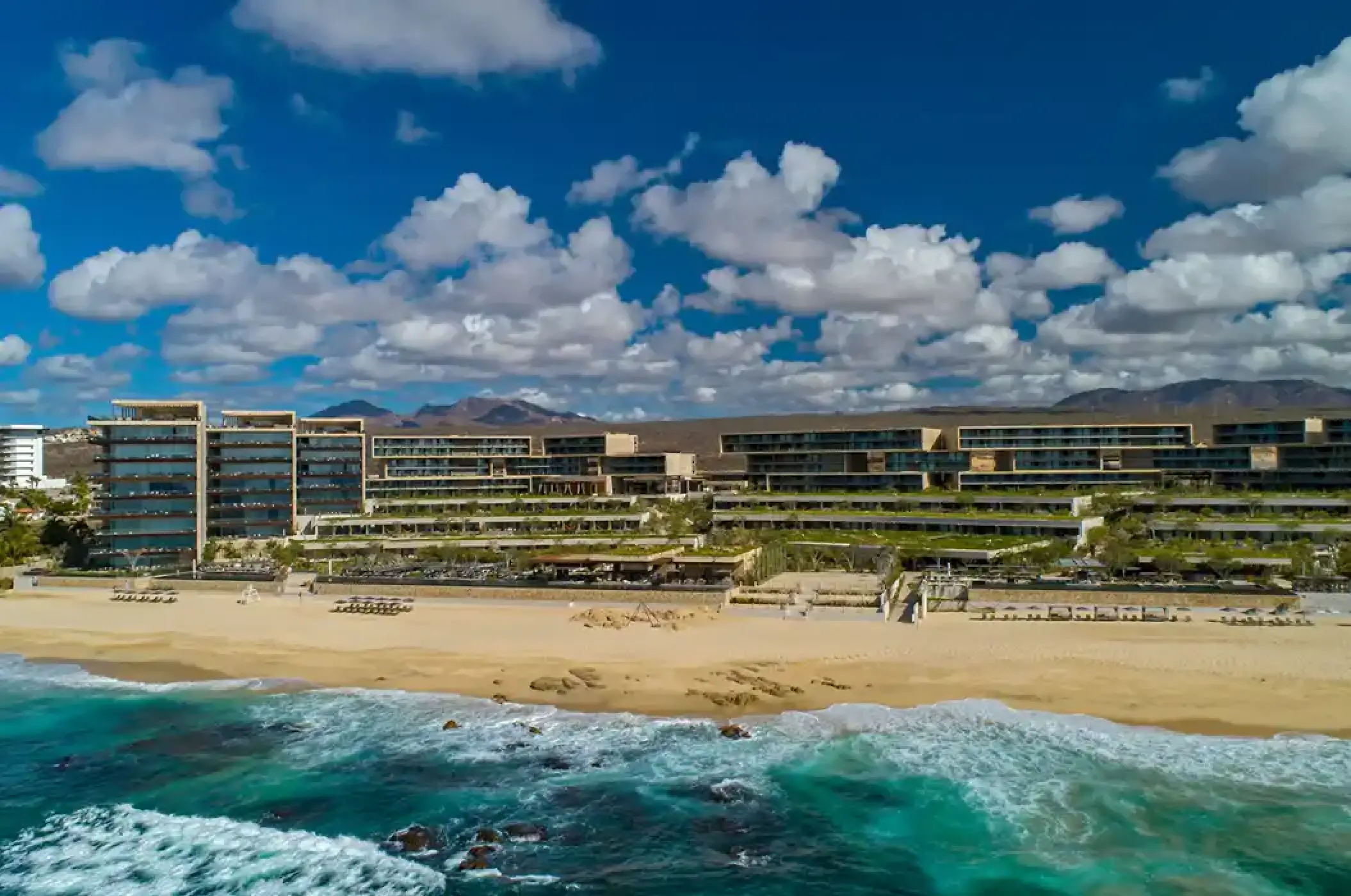 Aerial view of Solaz Los Cabos beachfront buildings and waves, Cabo San Lucas