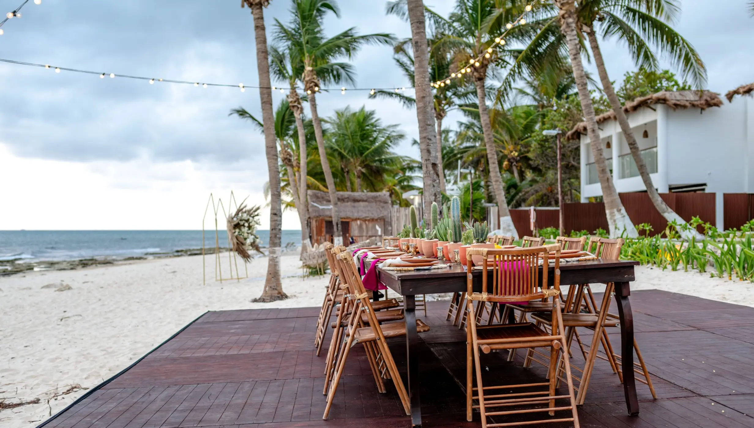 Beachfront wedding reception setup under palm trees at The Beachfront by The Fives, Playa Del Carmen