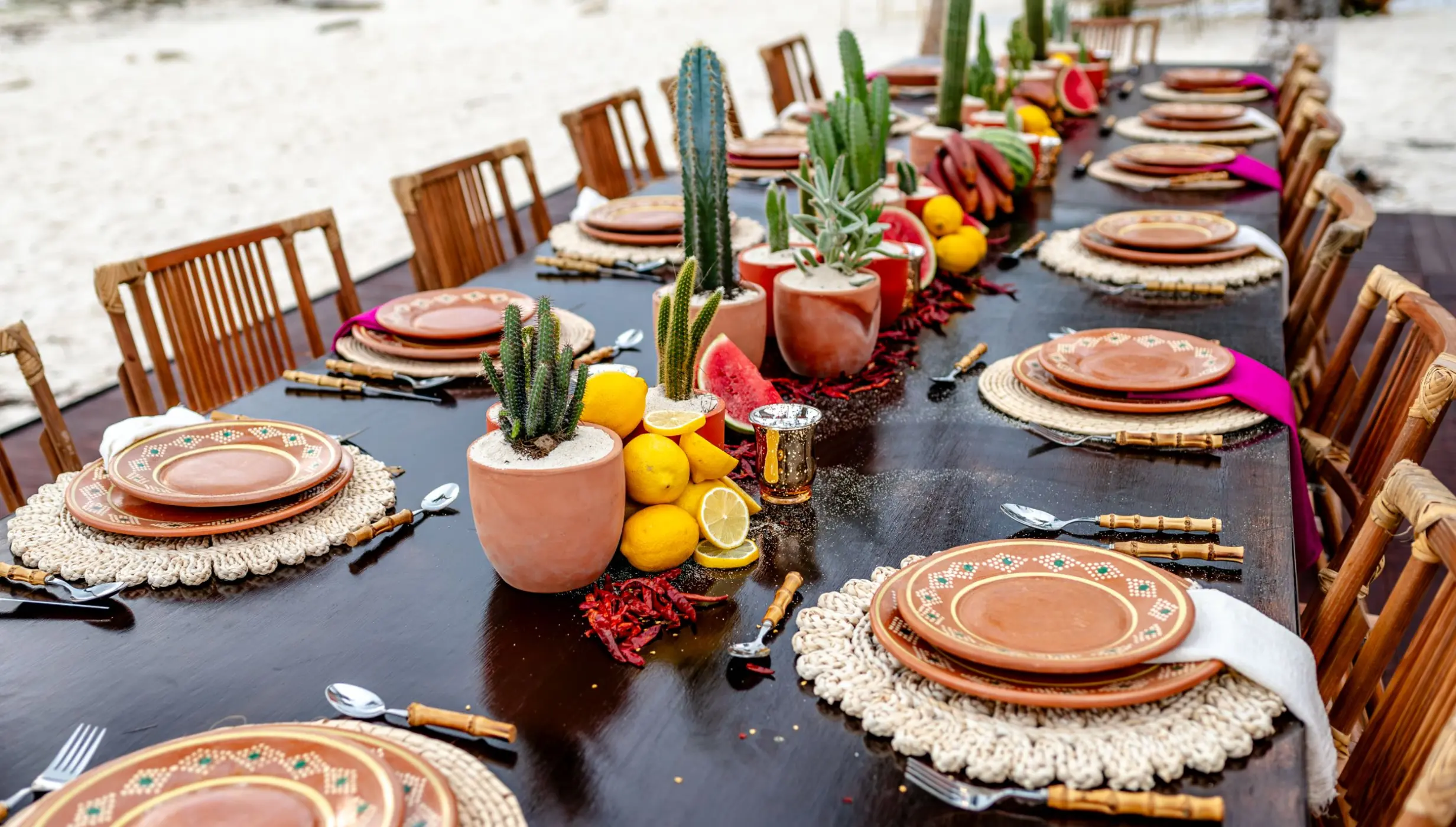 Beachfront wedding reception setup with cacti and fruit centerpieces at The Beachfront by The Fives, Playa Del Carmen