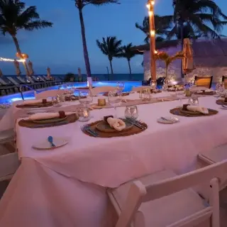 Outdoor wedding reception table setup under string lights at The Beachfront by The Fives, Playa Del Carmen
