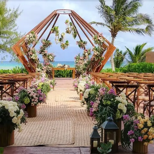 Beachfront wedding ceremony with geometric wooden arch at The Fives Beach Hotel, Playa Del Carmen