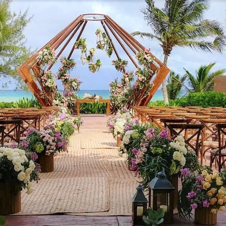 Beachfront wedding ceremony with geometric wooden arch at The Fives Beach Hotel, Playa Del Carmen