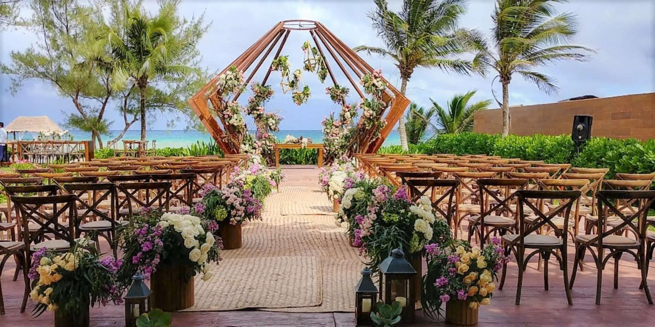 Beachfront wedding ceremony with geometric wooden arch at The Fives Beach Hotel, Playa Del Carmen