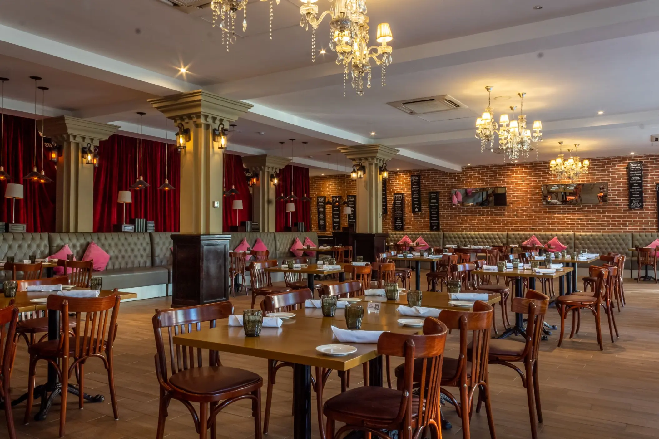 Brasserie restaurant with crystal chandeliers and red curtains at The Fives Beach Hotel, Playa Del Carmen