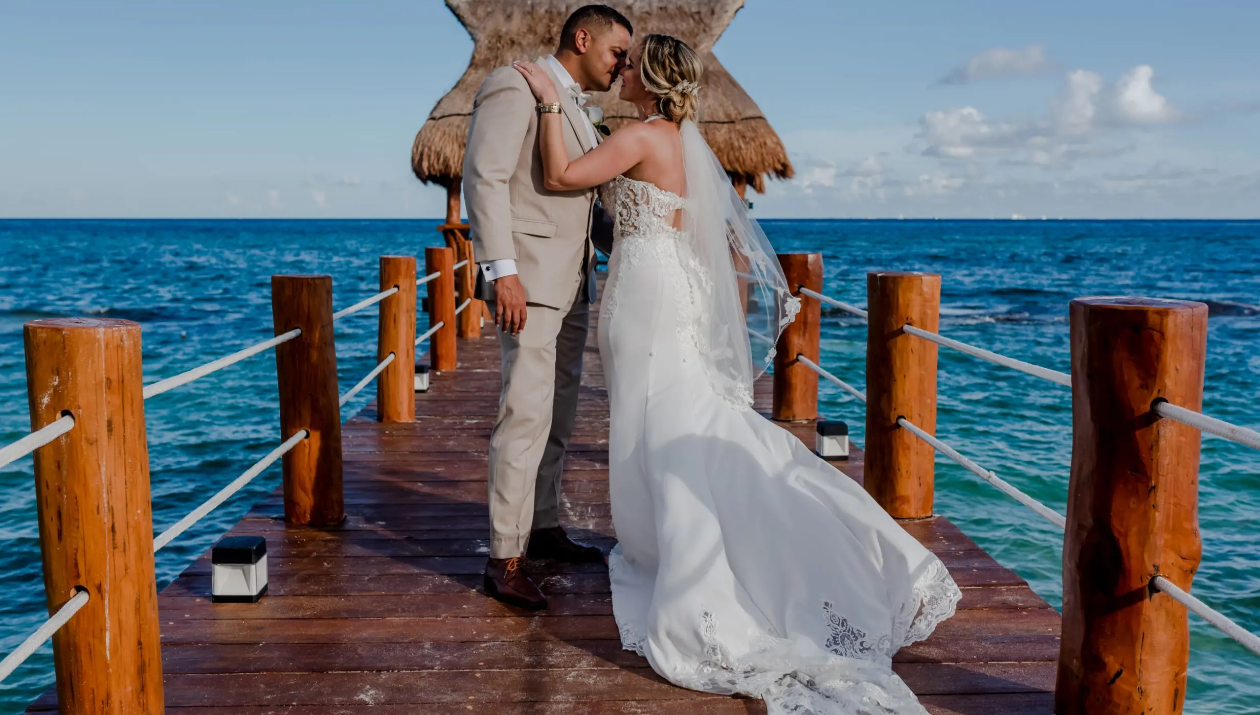 bride and groom at the pier at The Fives Beach Hotel & Residences