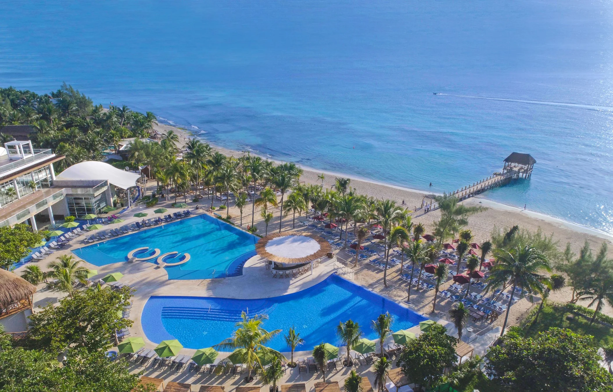 aerial view of the pools and beach at The Fives Beach Hotel & Residences