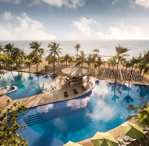aerial view of the pools and beach at The Fives Beach Hotel & Residences