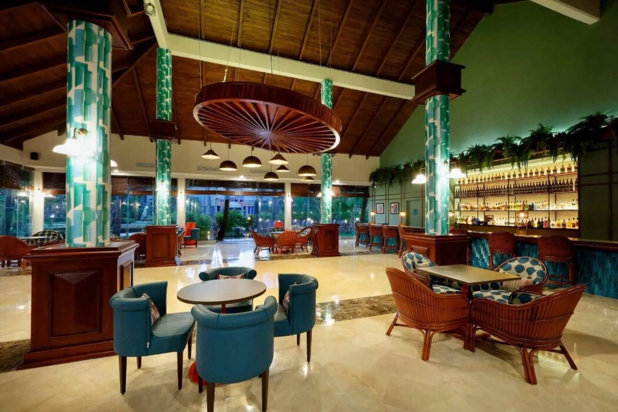 Indoor lobby bar with teal columns and vaulted ceilings at TRS Turquesa, Punta Cana