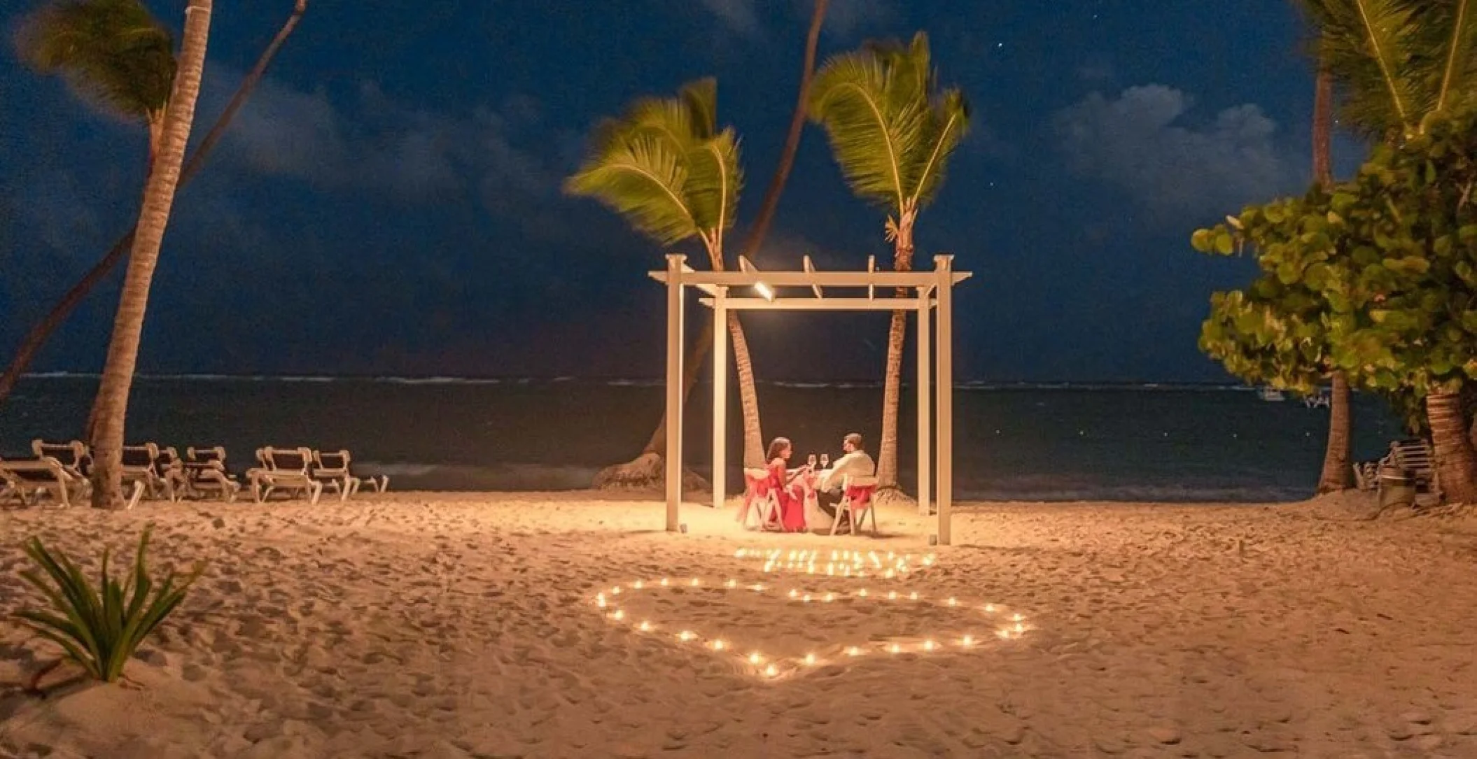 couple having romantic dinner on the beach at TRS Turquesa