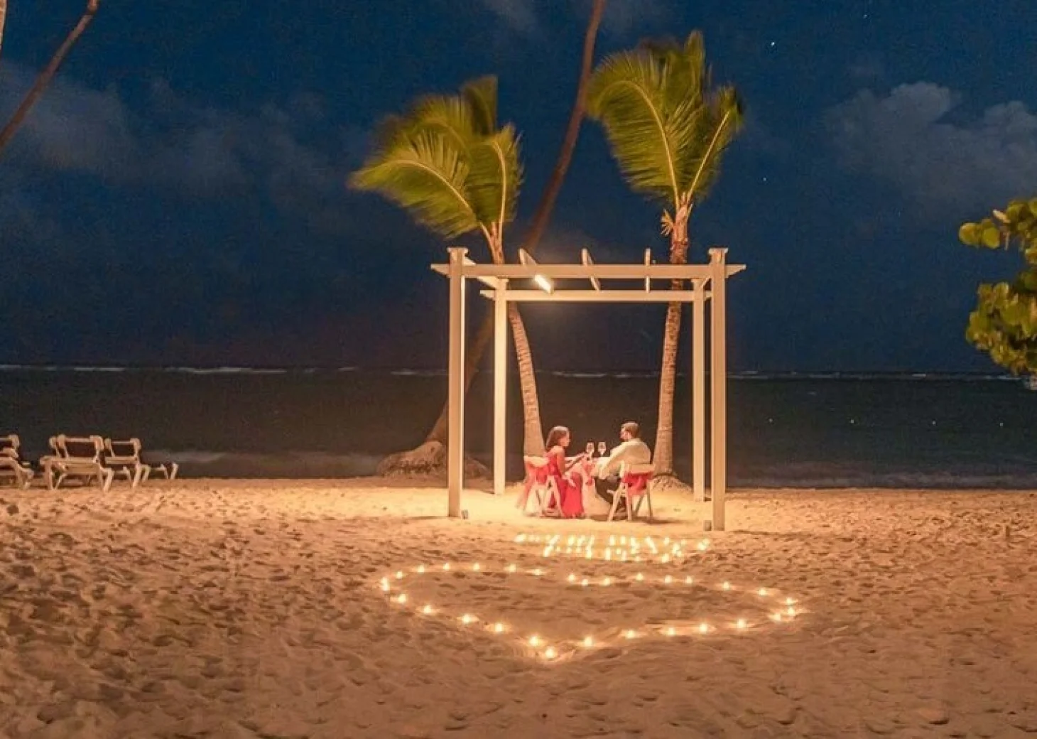 couple having romantic dinner on the beach at TRS Turquesa