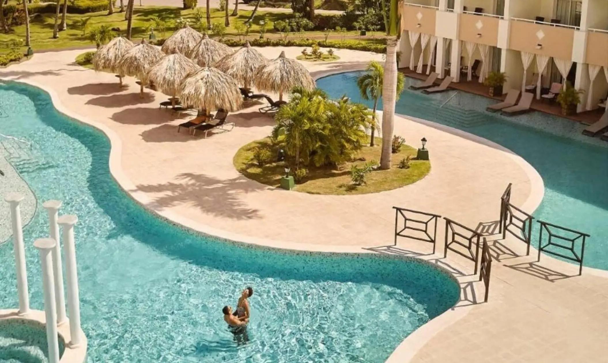 TRS Turquesa winding swimming pools and guest suites with palapa umbrellas, Punta Cana