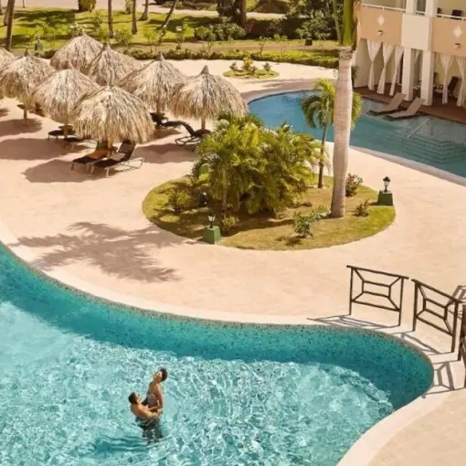 TRS Turquesa winding swimming pools and guest suites with palapa umbrellas, Punta Cana