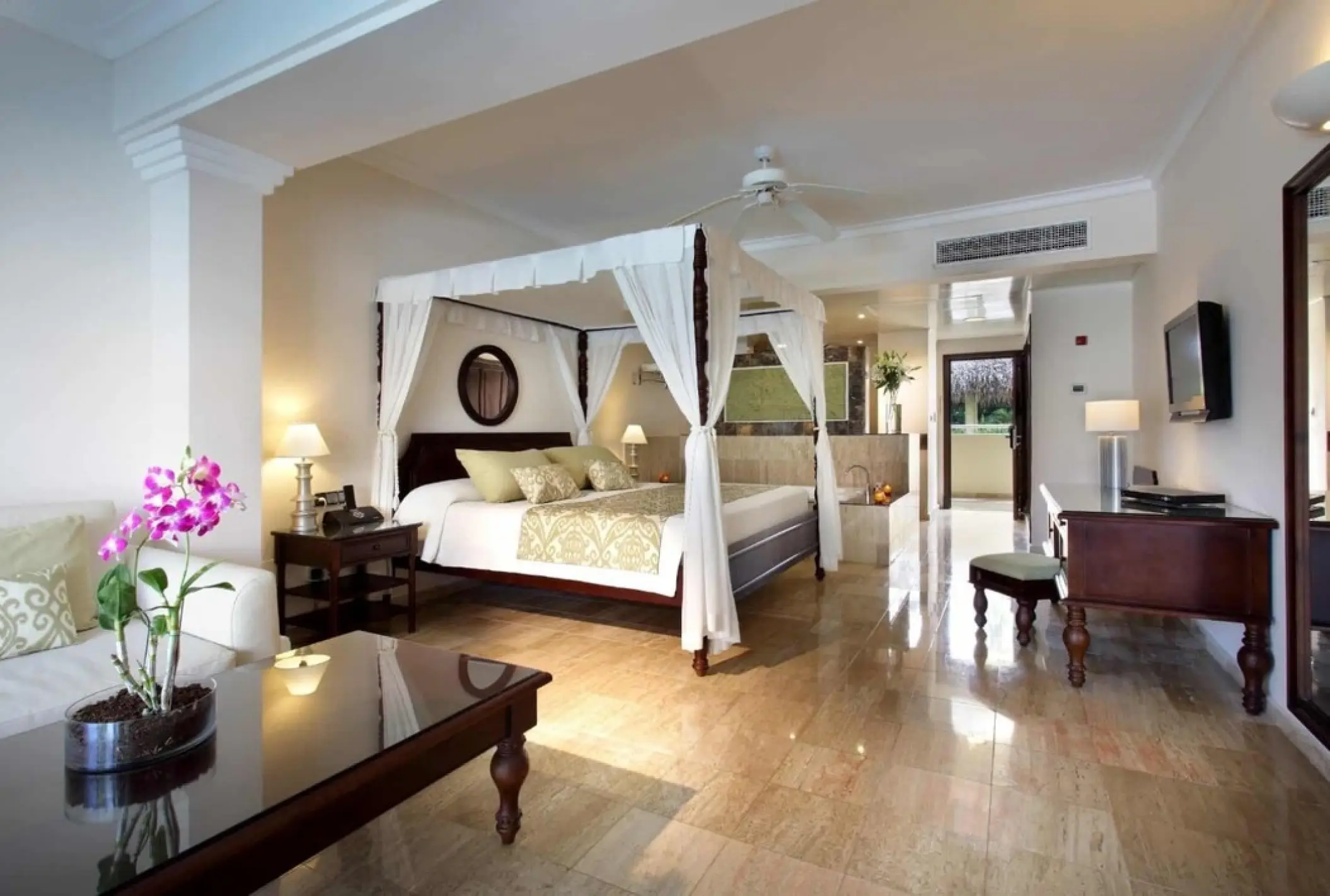TRS Turquesa guest suite with a four-poster canopy bed and marble flooring, Punta Cana