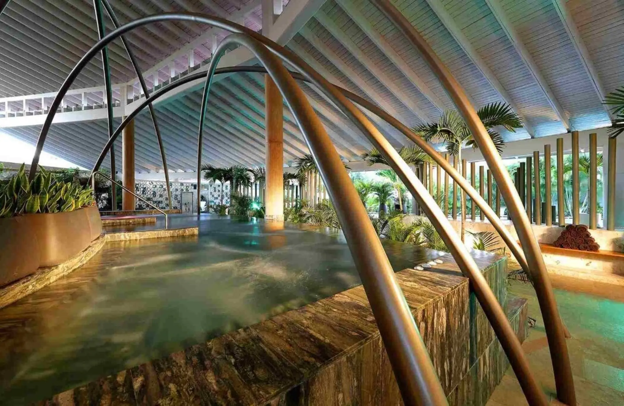 Indoor spa hydrotherapy circuit with arched water features at TRS Turquesa, Punta Cana