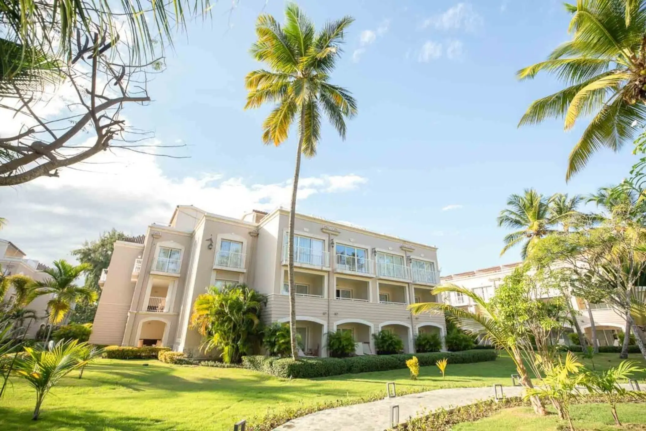 TRS Turquesa resort buildings and landscaped gardens with palm trees, Punta Cana
