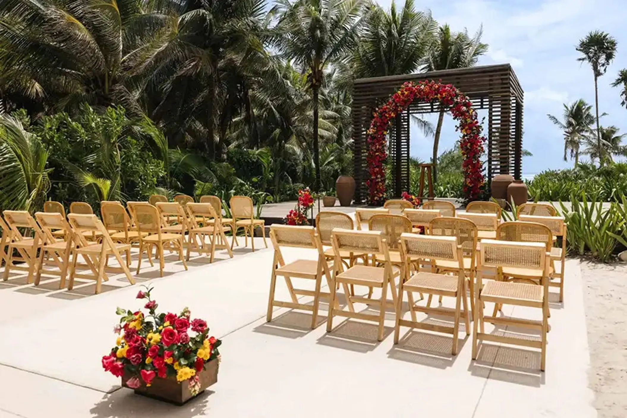 Modern gazebo wedding ceremony setup with red floral arch at UNICO 20°87°, Riviera Maya