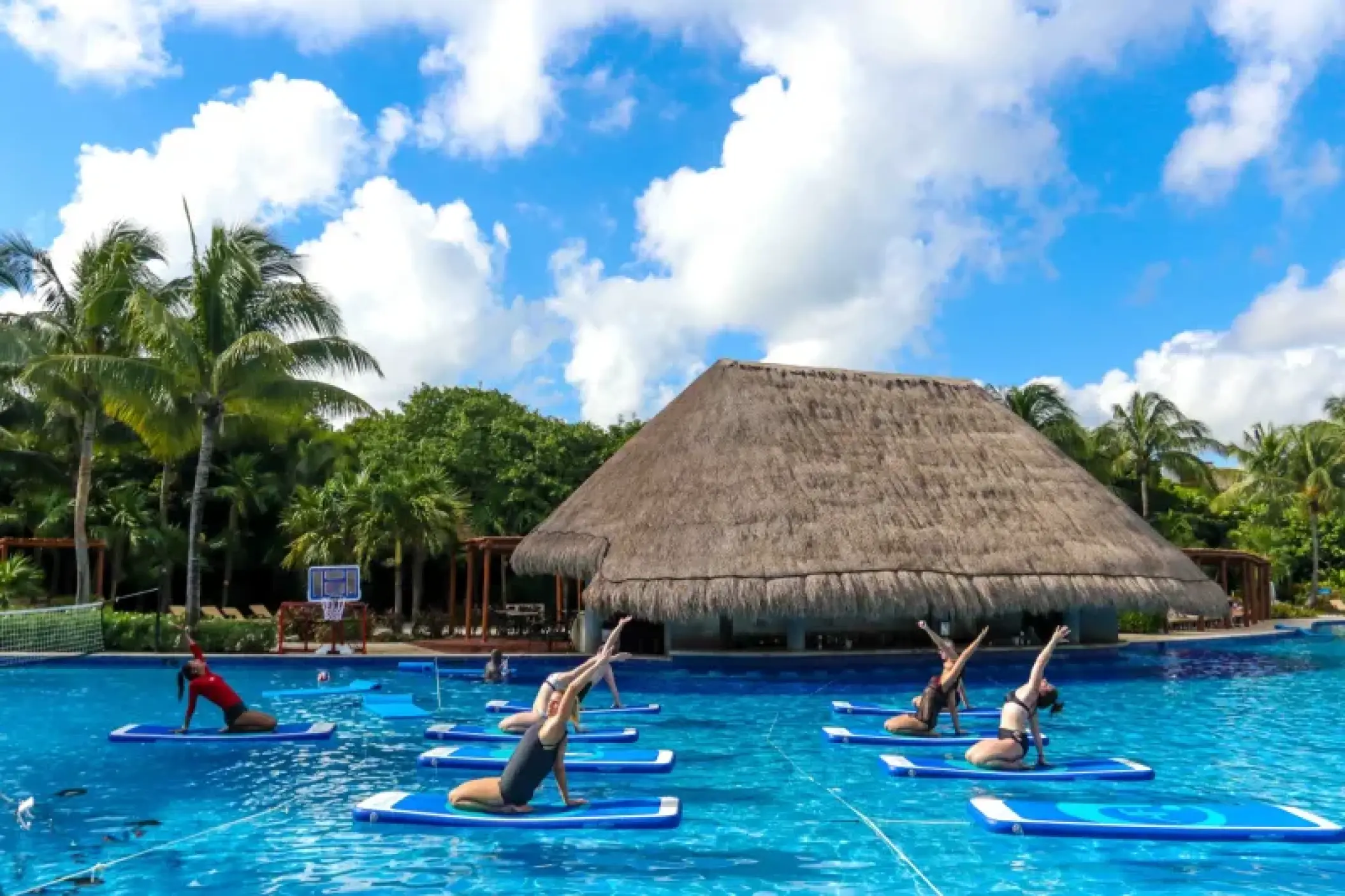 Group aqua yoga class on floating mats at Valentin Imperial Riviera Maya