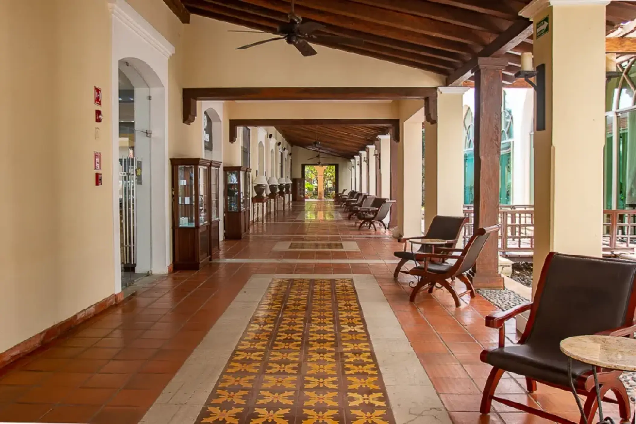 Open-air lobby hallway with wood beams and seating at Valentin Imperial, Riviera Maya