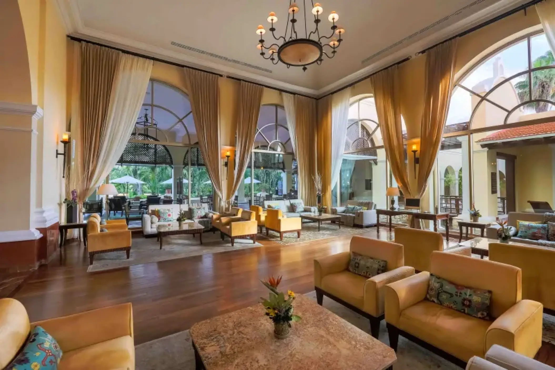 Valentin Imperial Riviera Maya lobby with high ceilings, arched windows, and yellow armchairs, Riviera Maya