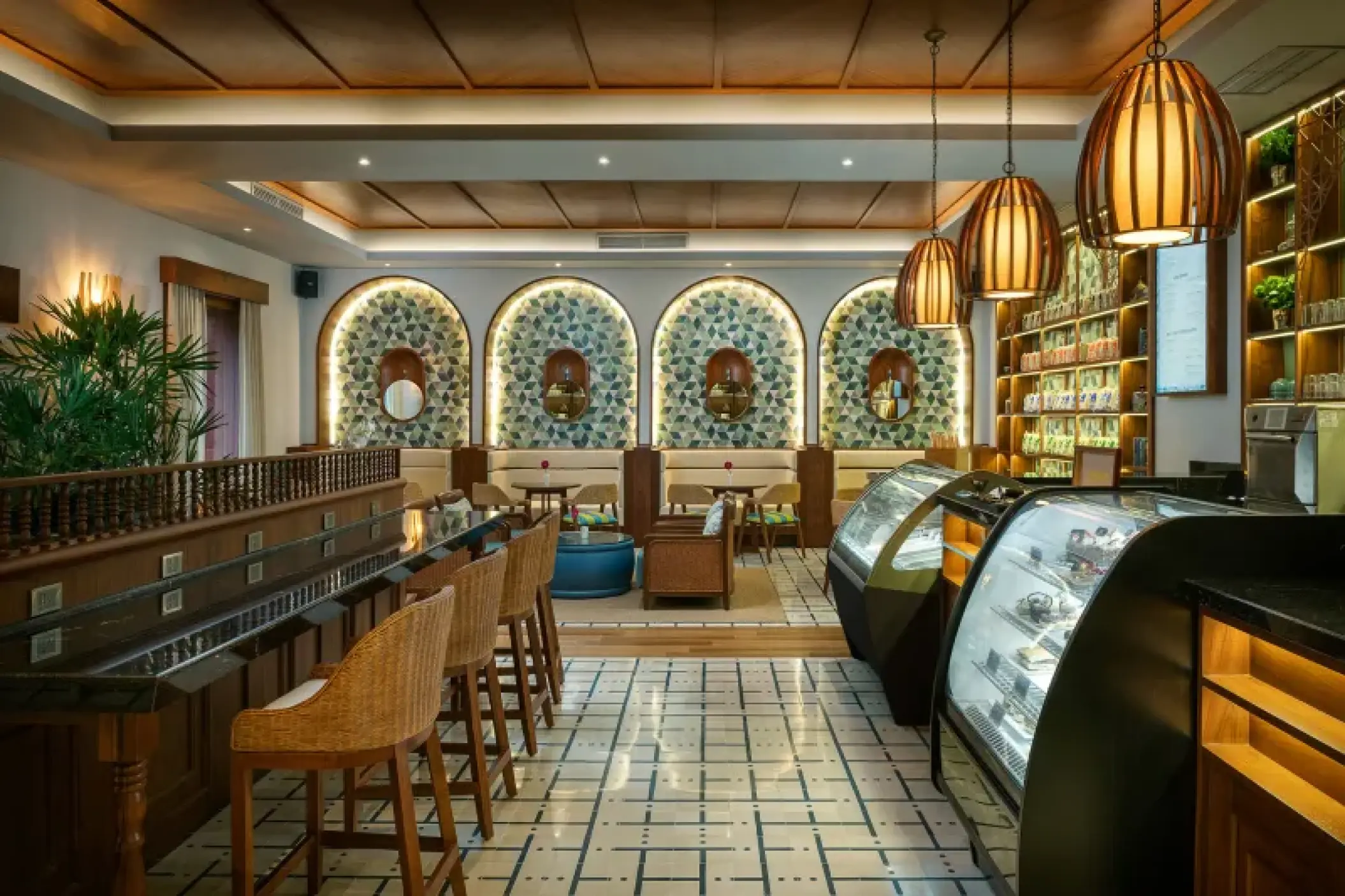 Cafe Sisal at Valentin Imperial Riviera Maya featuring arched seating nooks and warm pendant lighting