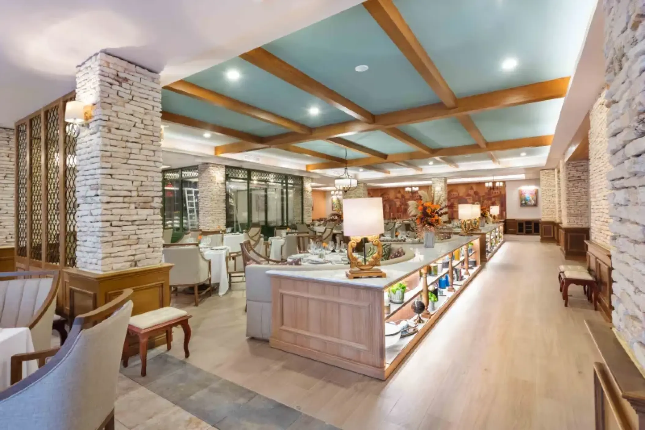 El Olivo restaurant interior with stone pillars and wood-beamed ceilings at Valentin Imperial, Riviera Maya