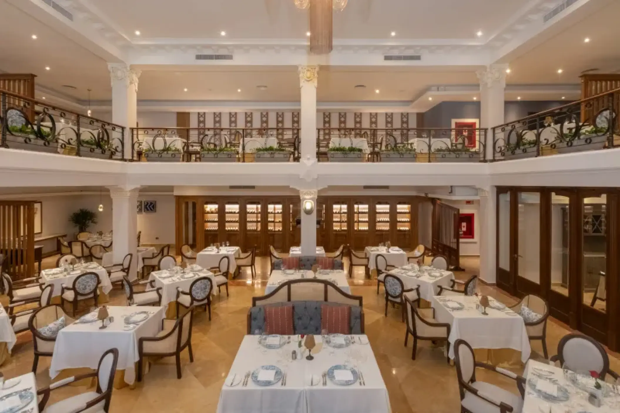 Elegant two-story restaurant interior with white tablecloths at Valentin Imperial, Riviera Maya