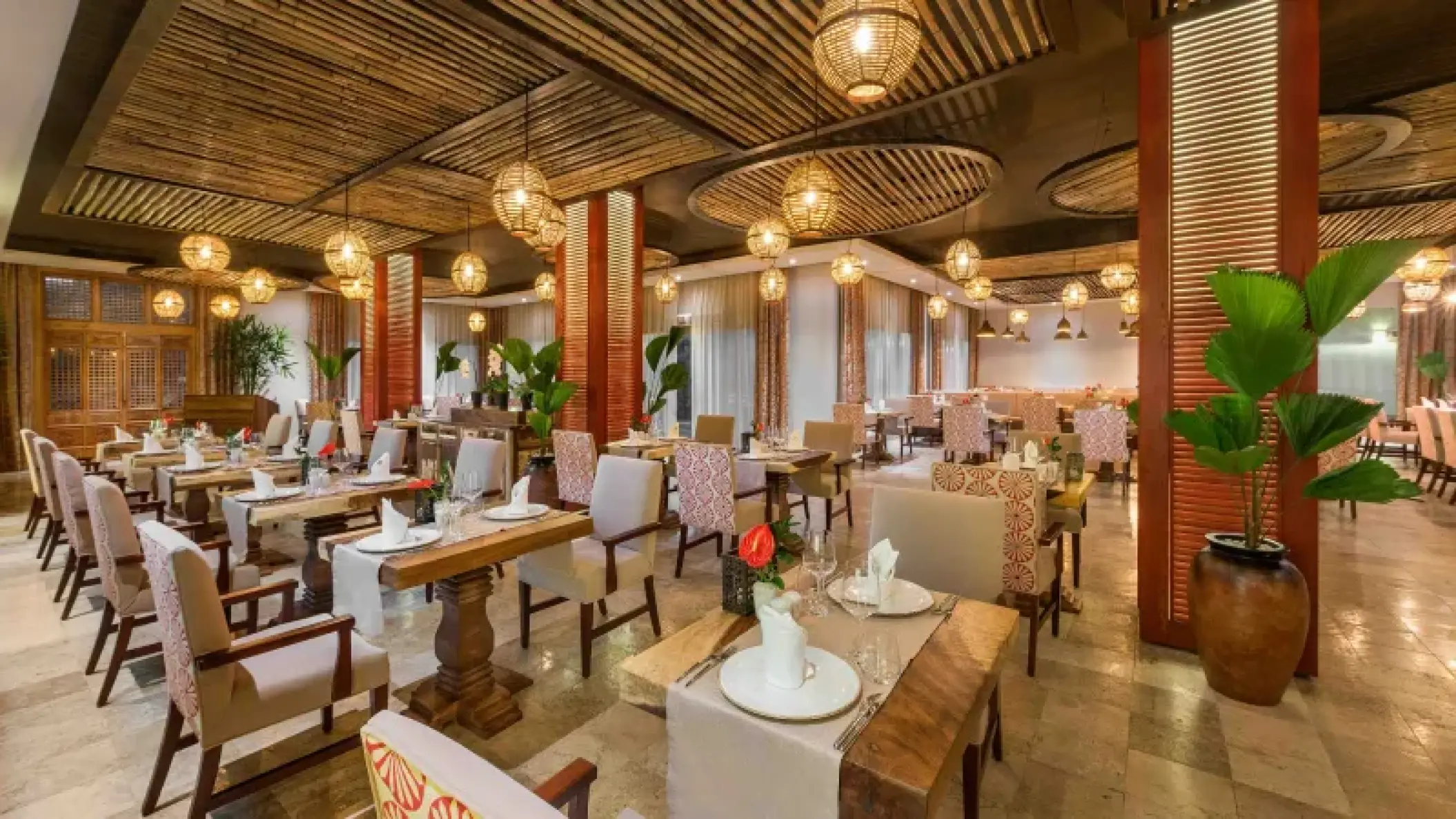 Tamansari restaurant dining room with wicker globe lights at Valentin Imperial, Riviera Maya