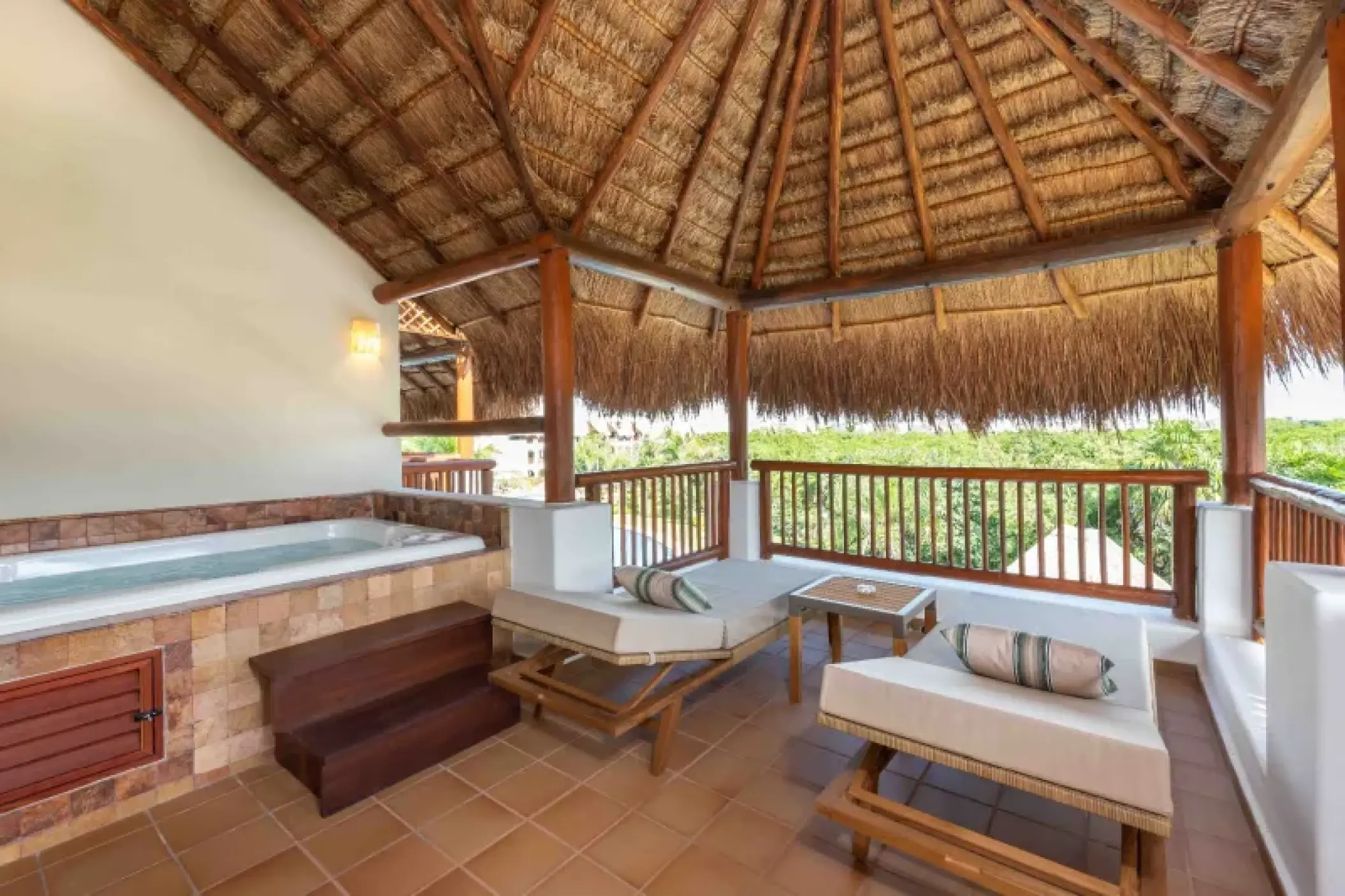 Diamond Suite balcony with whirlpool tub and loungers under a palapa roof at Valentin Imperial, Riviera Maya