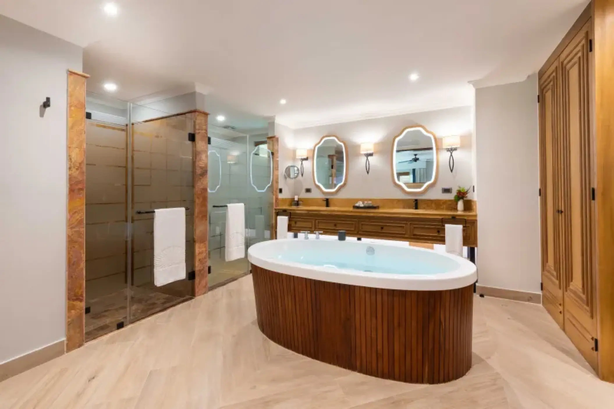 Diamond Suite bathroom with oval soaking tub and glass showers at Valentin Imperial Riviera Maya