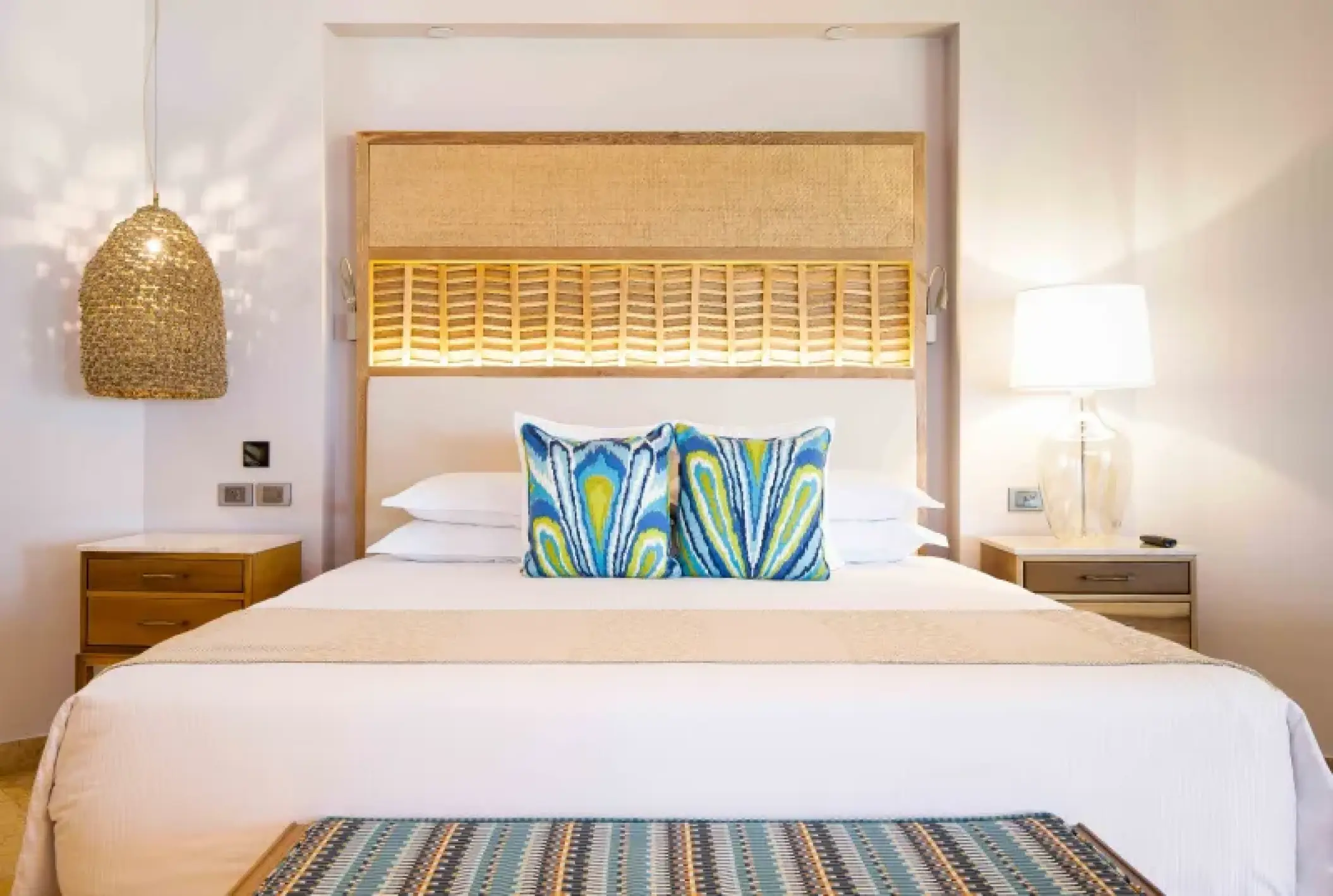 Valentin Imperial Riviera Maya Emerald Suite bedroom with woven headboard and teal accent pillows, Riviera Maya