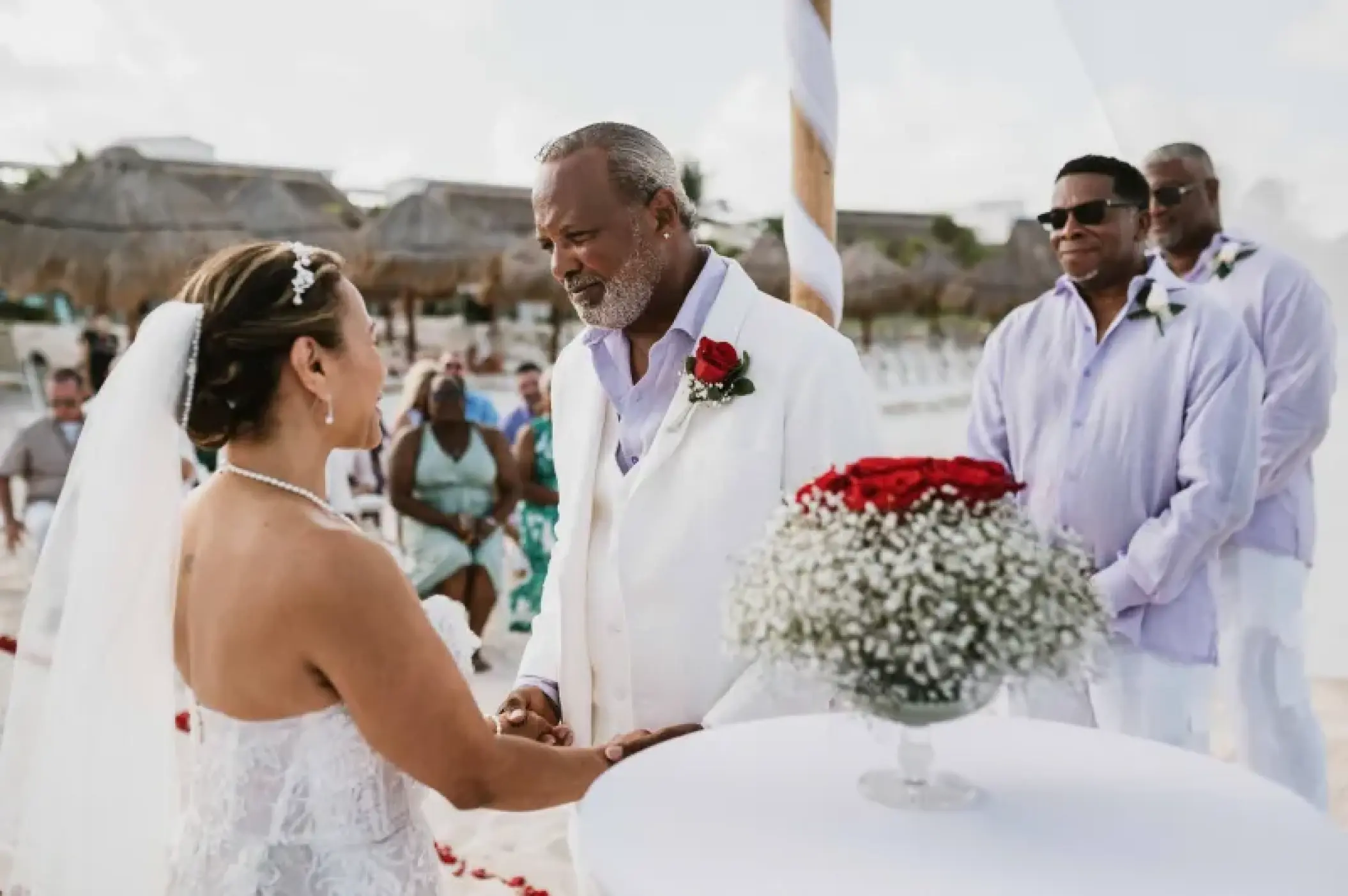 Bride and groom exchanging vows during a beach ceremony at Valentin Imperial, Riviera Maya