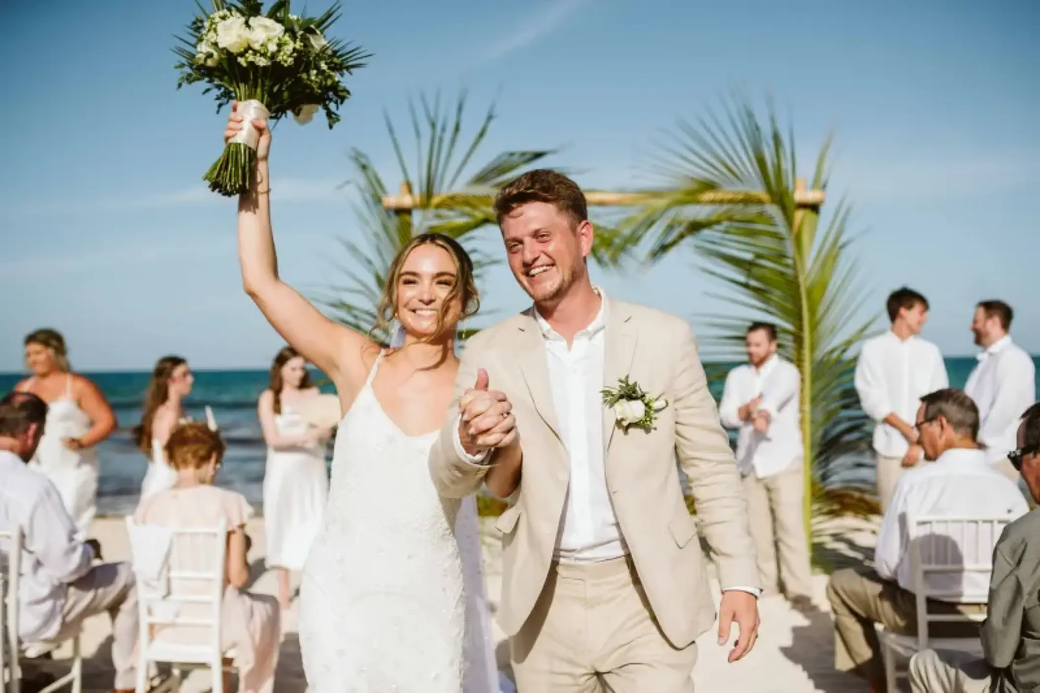 Newlyweds celebrating a beach ceremony at Valentin Imperial, Riviera Maya