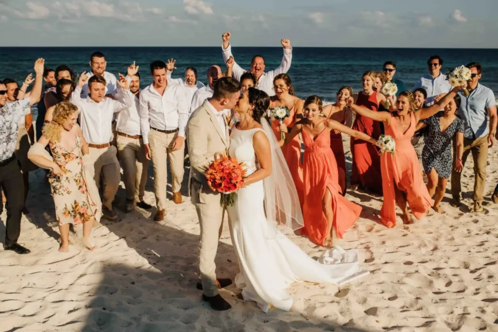 Bride and groom kissing during a beach wedding party at Valentin Imperial, Riviera Maya