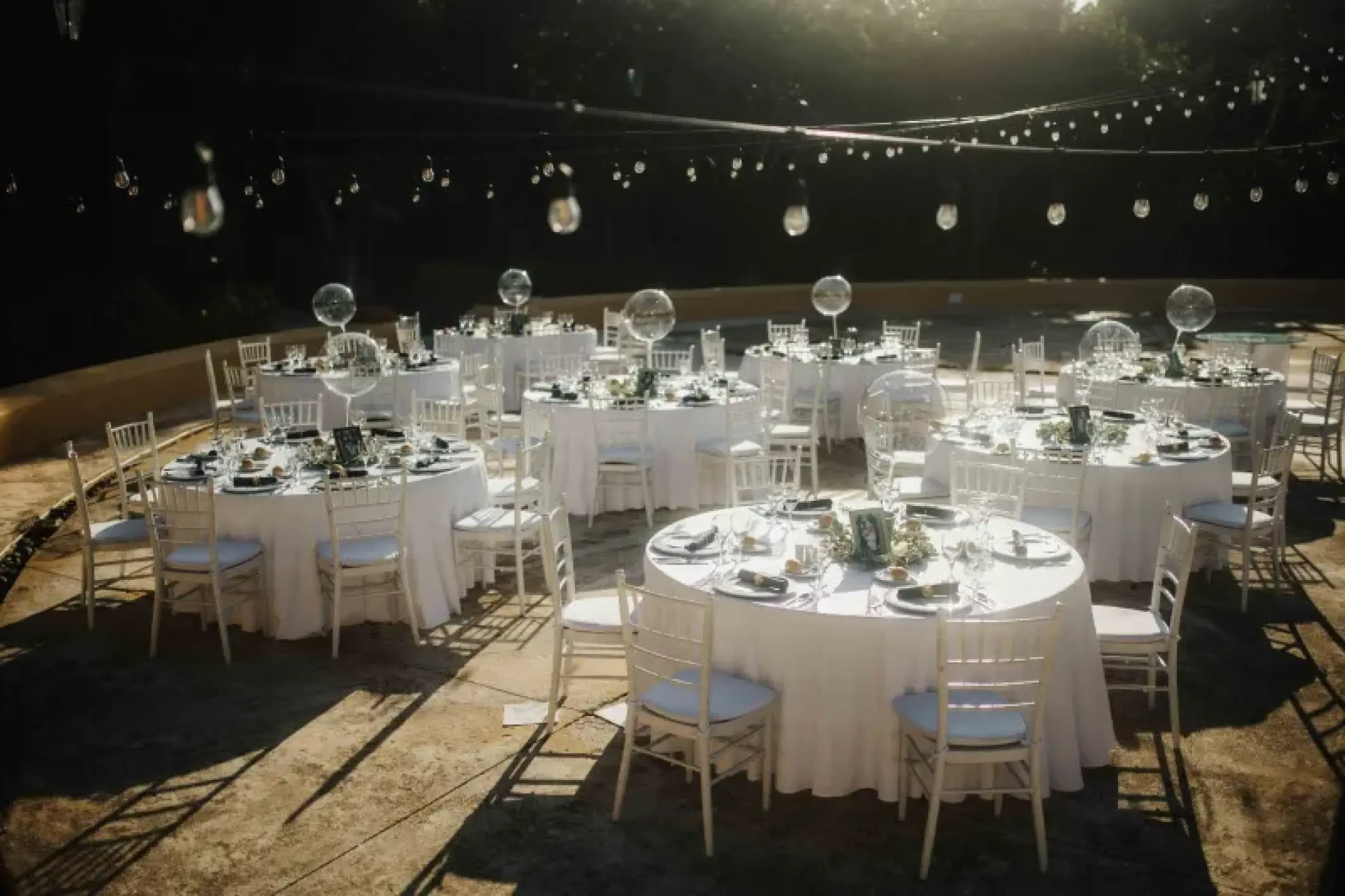 Outdoor wedding reception with white tables and string lights at Valentin Imperial, Riviera Maya