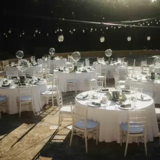 Outdoor wedding reception with white tables and string lights at Valentin Imperial, Riviera Maya