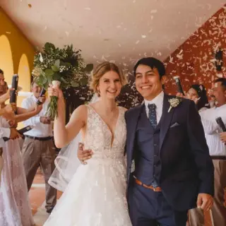 The bride and groom walking through confetti after their wedding ceremony at Valentin Imperial, Riviera Maya