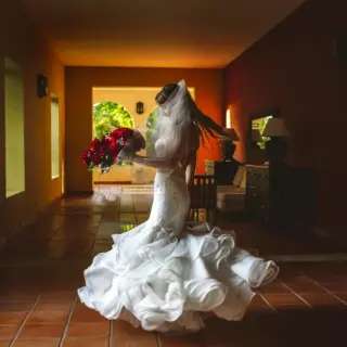 Bride twirling in her wedding dress in the foyer at Valentin Imperial, Riviera Maya